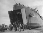 US Navy LST-134 and LST-325 beached at Normandy, France as jeeps driving along the invasion beach carry casualties to the waiting vessels, 12 Jun 1944, photo 3 of 4