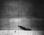 Japanese Patrol Boat #39 sinking after being torpedoed by American submarine Seawolf, 23 Apr 1943; seen from Seawolf