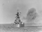 HMS Rodney firing on German positions along the Normandie coast off Caen, France, 7 Jun 1944; photo taken from frigate HMS Holmes