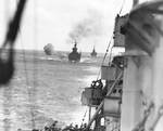 USS Minneapolis (foreground), USS San Francisco (center, with 8-inch gun smoke), and USS New Orleans (background) bombard Wake, 5 Oct 1943