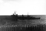 The cerws of USS Saratoga (foreground) and HMNZS Gambia (center) saluting each other as USS Saratoga was preparing to leave Indian Ocean, 18 May 1944