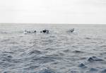 Boarding party from Coast Guard cutter Spencer approaching the U-175 after the sub was forced to the surface by depth charges, North Atlantic, 500 nautical miles WSW of Ireland, 17 Apr 1943. Minutes later, U-175 sank.