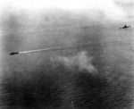 Yamato with a destroyer, listing heavy to port, 7 Apr 1945