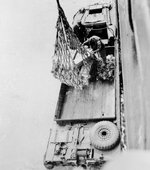 Men of the British 2nd Engineering Special Brigade lower cargo net into a DUKW at Inchon, Korea, 12 Jun 1951.