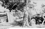 German soldier standing next to a 7.5 cm PaK 40 gun, Eastern Front, 21 Jun 1944