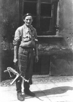 Polish resistance fighter Roman Marchel posing with a captured MP 40 submachine gun during the Warsaw Uprising, Ciepla Street, Warsaw, Poland, 20 Aug 1944