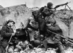 Three Soviet soldiers taking a break from fighting while a fourth stood guard, Byelorussia, 1 Apr 1944