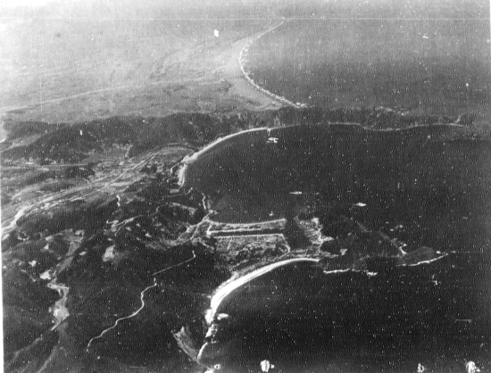 Suo (now Suao) harbor under attack by a PB4Y-1 aircraft of US Navy squadron VPB-104, eastern Taiwan, 22 Apr 1945, photo 2 of 4