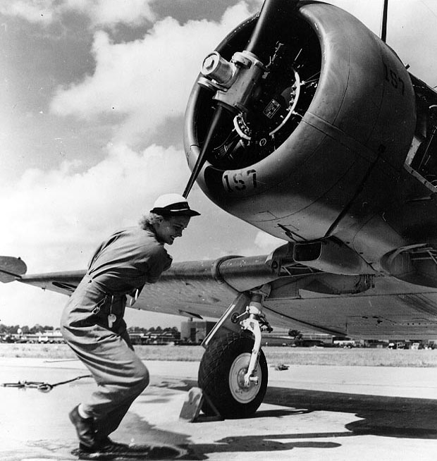 WAVES Aviation Machinist's Mate 3rd Class Violet Falkum turning the Pratt & Whitney R-1340 radial engine of a SNJ-4 training plane, Naval Air Station, Jacksonville, Florida, United States, 30 Nov 1943