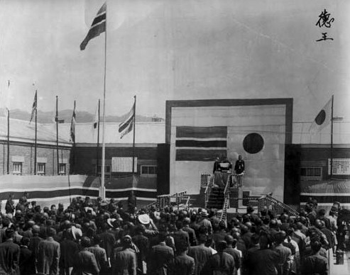 Foundation ceremony of the Japanese puppet nation of Mengjiang, Kalgan (now Zhangjiakou), Chahar Province, China, Sep 1939; Demchugdongrub's name in Chinese on the upper right portion, thus he might be the speaker in the photograph