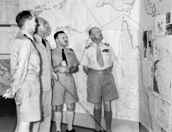 Lieutenant General Gordon Bennett discussing strategy with RAN Commodore C. J. Pope, USN Captain A. R. McCann, and RAAF Air Commodore R. J. Brownell, Australia, Feb 1943