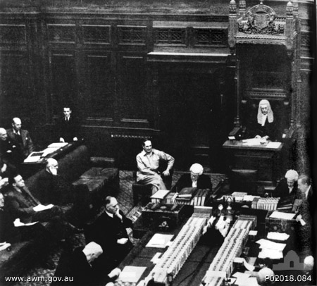 MacArthur seated next to the Speaker of the House of Representatives Mr. Nairn, Provisional Parliament House, Canberra, Australia, 1942; note Curtin seated at table