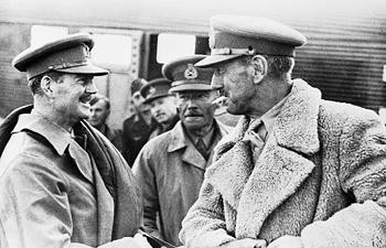 Philip Neame, Richard O'Connor, Richard Parry, and John Coombe in captivity, 6 Apr 1941; note Ju 52 aircraft in background