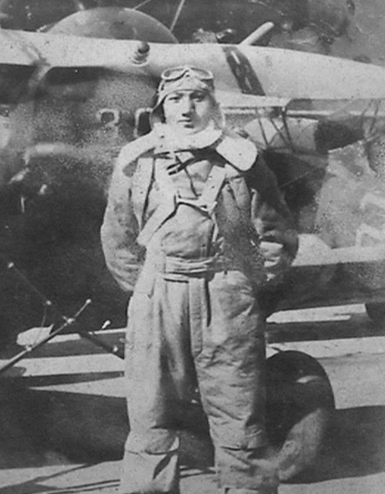 Yue Yiqin in full flight gear with a Hawk III fighter, China, 1930s