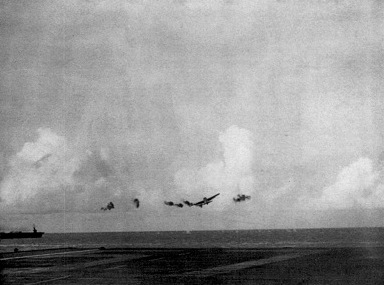 FM-2 fighter being launched from USS Coral Sea during combat off Saipan, Mariana Islands, 18 Jun 1944; note USS Corregidor in background