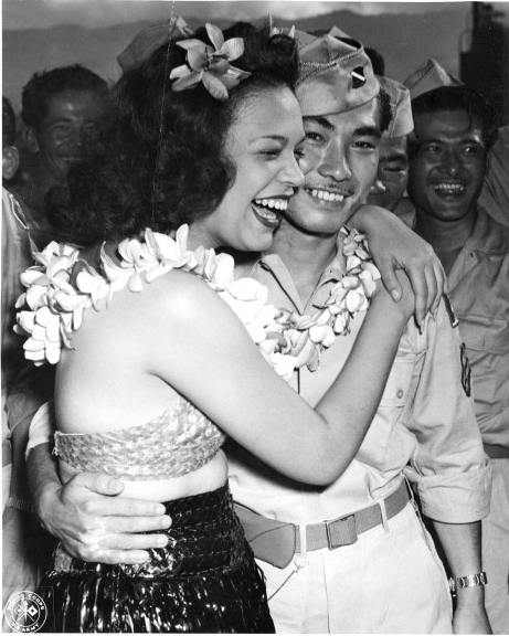 Hula dancers entertain returning Japanese-American veterans of US 442nd Regimental Combat Team aboard Victory Ship USS Waterbury Victory, Honolulu, US Territory of Hawaii, 9 Aug 1946; photo 5 of 7