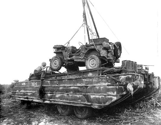 A Jeep being lowered into a DUKW on Tinian, Mariana Islands, 1945