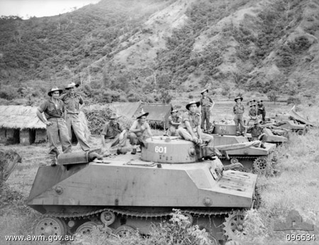 Soldiers of Australian 37/52 Infantry Battalion posing with captured Japanese Type 2 Ka-Mi amphibious tanks, near Lakunai airstrip and Rabaul, New Britain, Solomon Islands, 14 Sep 1945