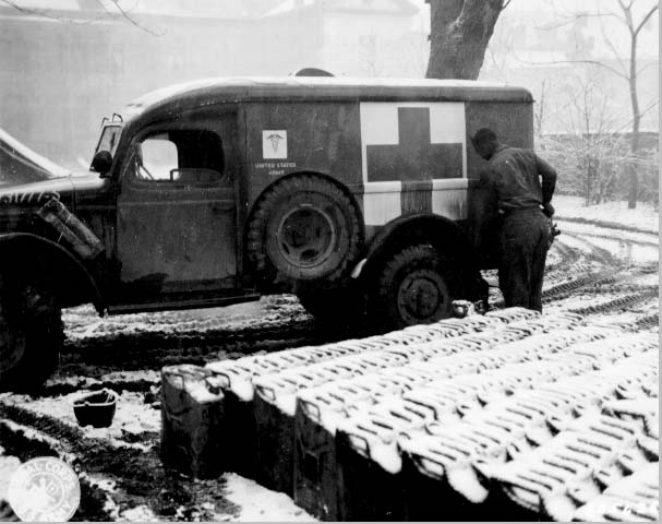 Private Booker Davis of Philadelphia, Pennsylvania, United States of the 558th Ambulance Company, US First Army filling a WC54 ambulance with gasoline, Belgium, 4 Jan 1945