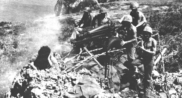 US Marine Corps 75-mm howizer 'Miss Connie' firing into Japanese-held caves, Tinian, Mariana Islands, Jul-Aug 1944; note M8 carriage