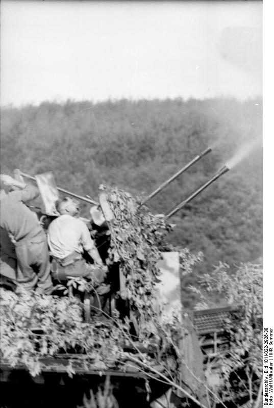 Camouflaged German 2 cm Flakvierling 38 anti-aircraft gun mounted atop a SdKfz. 7 half-track vehicle, immediately prior to Battle of Kursk, summer 1943, photo 2 of 2